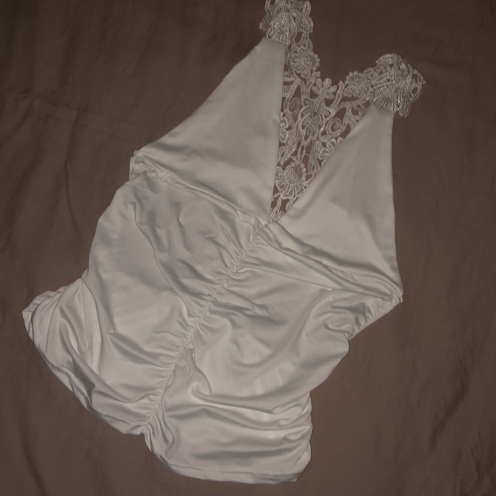 Silky backless tank top with strappy lace on back.